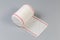 Roll of the woven elastic medical bandage on gray background