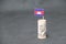 Rolled banknote money five hundred Cambodian Riel and stick with mini Cambodia flag on dark grey floor and background