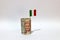 Rolled banknote money one thousand Lire Italy and stick with mini Italia nation flag on white background