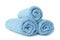 Rolled clean turquoise towels on white background