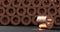 Rolled copper sheet isolated on dark background. Copper sheet is tiwsted into a large rolls. 3D illustration