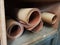 Rolled grit sand paper in a wood shelf