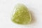 Rolled Grossular green garnet rock on white