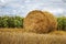 Rolled haystack on agriculture field landscape. Haystack farmland field panorama