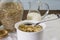 Rolled oats in bottle and cooked in bowl on table