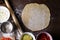 Rolled out a big circle of dough with space for text on a wooden table with ingredients for pizza or pie. top view, Flatley.