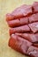 Rolled slices of bresaola, delicious typical italian raw beef salami, close up
