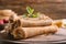 Rolled thin pancakes on wooden board, closeup