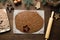 Rolled uncooked dough preparing for festive Christmas treats on kitchen table. View from above. Xmas traditional food