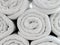 Rolled Up Light Gray Cotton Beach Towel Pattern used as Background Texture