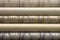 Rolled up rolls of vinyl wallpaper. Different textures and colors, as background. Beige, gray wallpapers with abstract