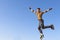 Roller boy jumping from parapet on the blue sky