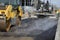 Roller machine compressing the asphalt behind the paver