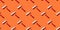 Roller for painting on an orange background, pattern, hard shadows. Construction tools, repairs. Background for the design
