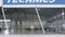 Roller shutter door and concrete floor of airport hangar and airplane background. Airport hangar from the outside with