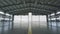 Roller shutter door and concrete floor inside factory building for industrial background. Airplane in front of half