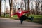 Roller skater doing balance exercise on sidewalk