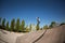 A roller skater jumps a ramp doing a trick in a skate park