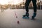 Roller skater legs in skates on asphalt walkway