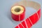 Roller tape red self-adhesive label. Material for printing and marking products. Thermal label. Selective focus, copy