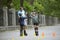 Rollerblading. Man trainer fooling around with boys in a park