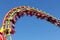 Rollercoaster against blue sky