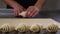 Rolling dough into croissant shape. Homemade sweet pastries. Modern bakery. Baker forming croissants. Making french