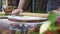 Rolling dough with rolling pin for pizza preparation on table. Chef hands rolling dough for pie with wooden roller