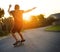 Rolling down the streets with some cool moves. Rear view shot of a young man skateboarding outside.