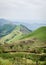 Rolling fertile hills with fields and crops on Ring Road of Cameroon, Africa