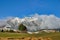 Rolling fields with snow covered mountains