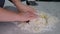 Rolling out potato dough for gnocchi. The process involves flour and potatoes.