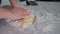 Rolling out potato dough for gnocchi. The process involves flour and potatoes.