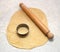 Rolling pin and cutter on fresh pastry, cutting out circles
