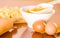 Rolling pin, eggs, pasta and dough spread out on wooden surface