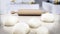 Rolling pin and fresh doughs standing on white table. 3D illustration