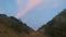 Rolling upland hill with reddish clouds during sunset somewhere in Timor-Leste.