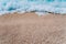 Rolling wave of blue turquoise sea water on pebble beach. Background. Top view