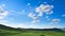 Rolling white clouds in blue sky, spring green grassland in Inner Mongolia
