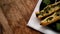 Rollini with brynza cheese and spinach on a black plate, wooden background