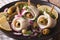 rollmops herring with olives, onions, pickles and lemon close-up. horizontal