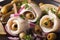 rollmops herring with olives, onions and pickles macro. horizontal