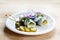 Rollmops or rolled pickled herring with red onions, gherkins and capers, a sour hangover breakfast on a wooden table, copy space