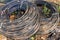 Rolls of black telecommunication cables lying on the ground.