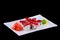 Rolls with crab meat, eel, avocado, mayonnaise, tobiko caviar on a white plate on black background