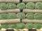 Rolls of grass lawn turf stacks stacked on wooden pallet tray