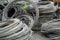 Rolls of metal or steel cables used for electric poles at an industrial yard