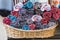 Rolls of multicolor towels in a wicker basket