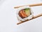 rolls and sushi isolated on white background with gel sticks. Delicious sushi roll with daily chopsticks on a white