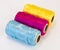 Rolls of thread with CMYK colors.